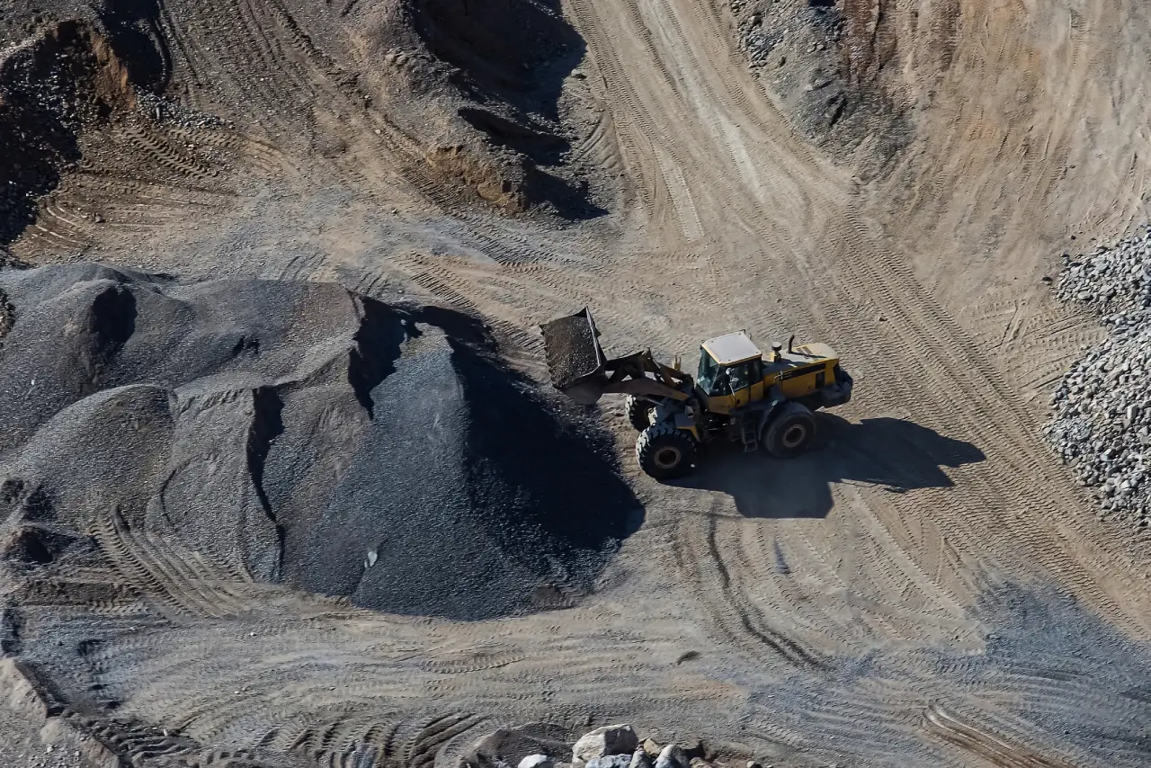 excavator-loading-dumper-truck-on-mining-site.webp