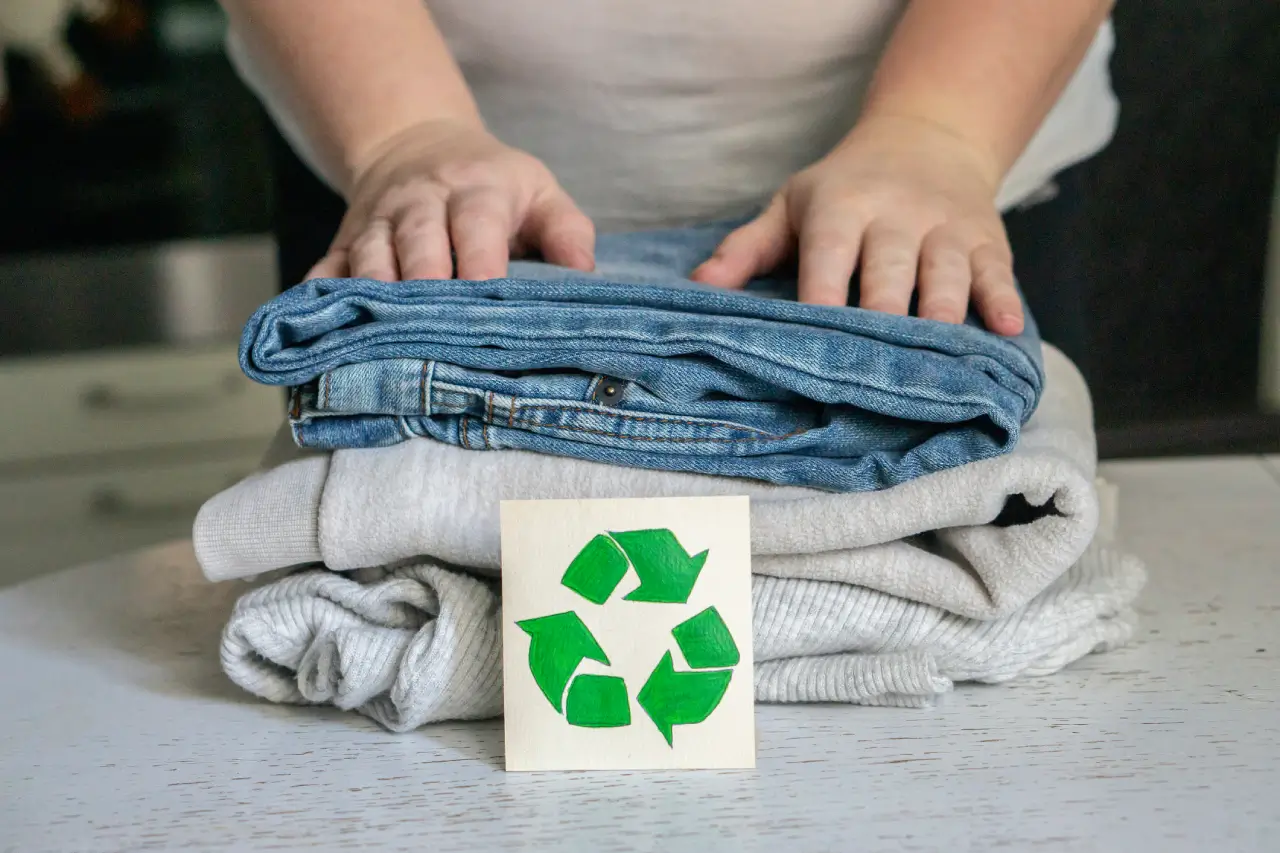 garment-recycling-concept-a-stack-of-clothes-is-on-the-recycling-table-collection.webp