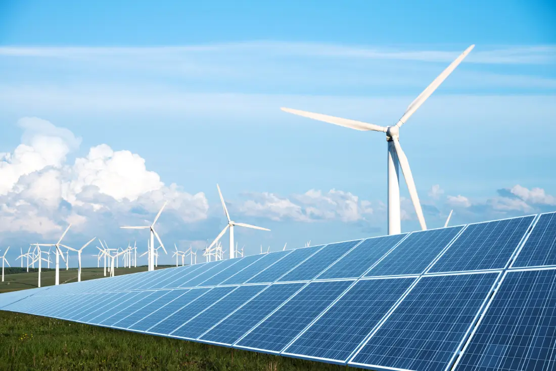 solar-panel-in-green-lawn-with-wind-power-station.webp